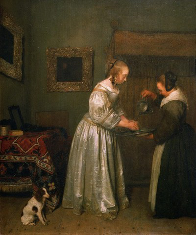 A lady washing her hands.